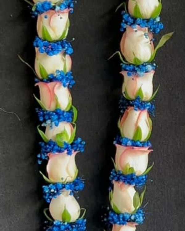 Cream rose garland with blue baby's breath