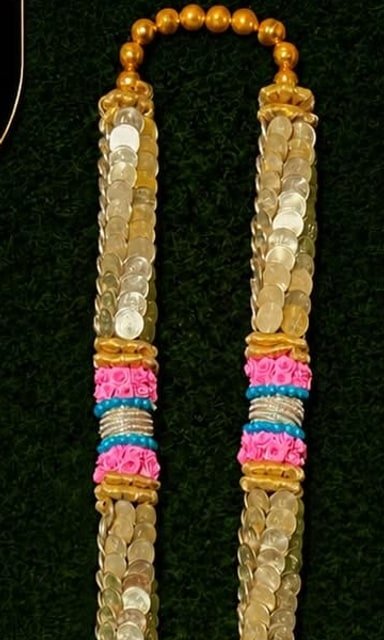 Gold-coin garland with floral accents