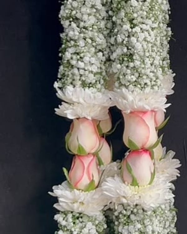 White chrysanthemum and rose garlands with baby's breath
